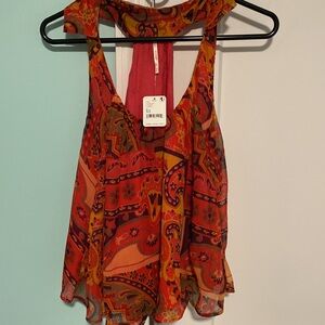 NWT Free People racer back flowy top  Strawberry tank. Easily fit a small